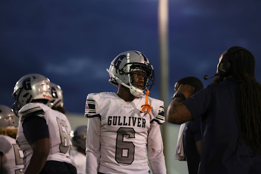 Caption- Senior wide receiver Kenny Willams gets the play call from offensive coordinator Tony Gaiter IV. Kenny would end the day with two touchdowns, one receiving and one rushing. “Once I see the ball in the air I know I gotta make that ball my ball,’’ Williams said. 