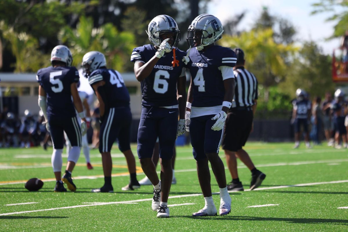 Senior defensive back/wide receiver Kenny Willams talks to junior defensive back/wide receiver Leondrez Leonard pre snap. Both players are having to play both on offense and defense this year.
