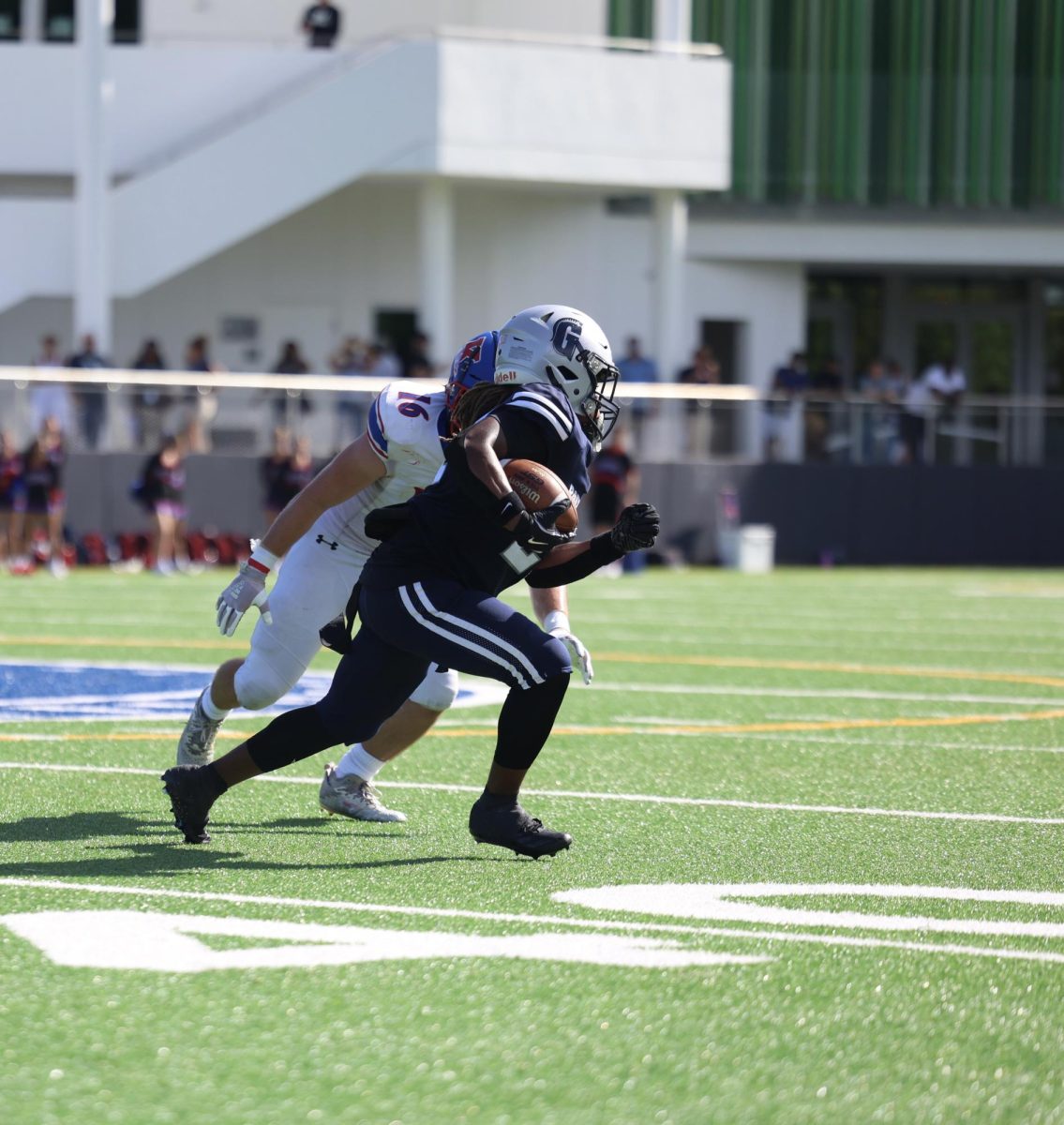 Sophomore running back Darriel Cannon attempts to evade the defender by running past him. Cannon has served the Raiders this year at safety and the lead running back. Cannon has served the team as a three down back being able to catch passes and pass block.   