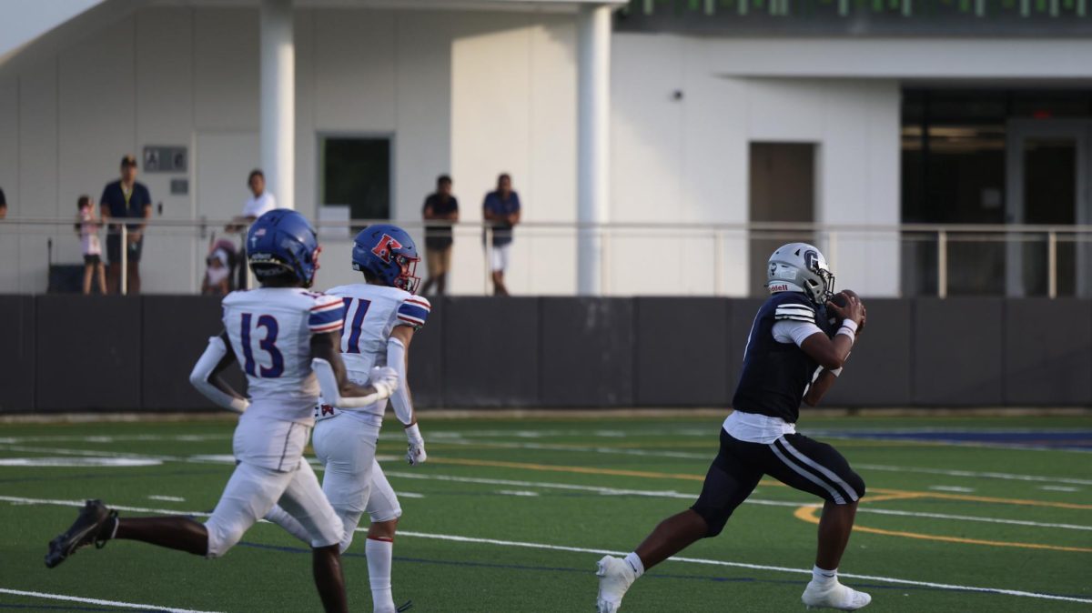 Junior wide receiver Luc Caroll runs past two defenders for a touchdown. Caroll would have many big plays in the 2nd half that helped the Raiders mount a comeback versus King’s Academy.  
