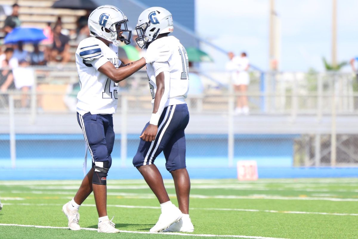 Sophomores Deandre Leonard and Maurice Gage dap each other up after Gage made a stop on third down. Both sophomores have played big parts in the team's defense this year.   