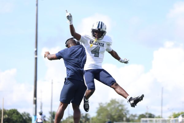 Junior defensive back Leandrez Leonard celebrates with defensive coordinator Frankie Telfort. Leonard would end the day with two interceptions helping the team win 30-12.   