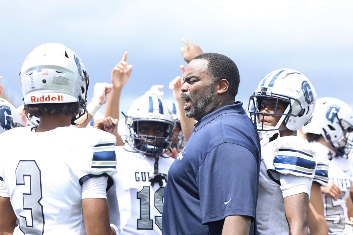 Head Coach Earl Sims gives a speech to the team after the game. The team beat Killian 30-12, marking the first win of the season. 