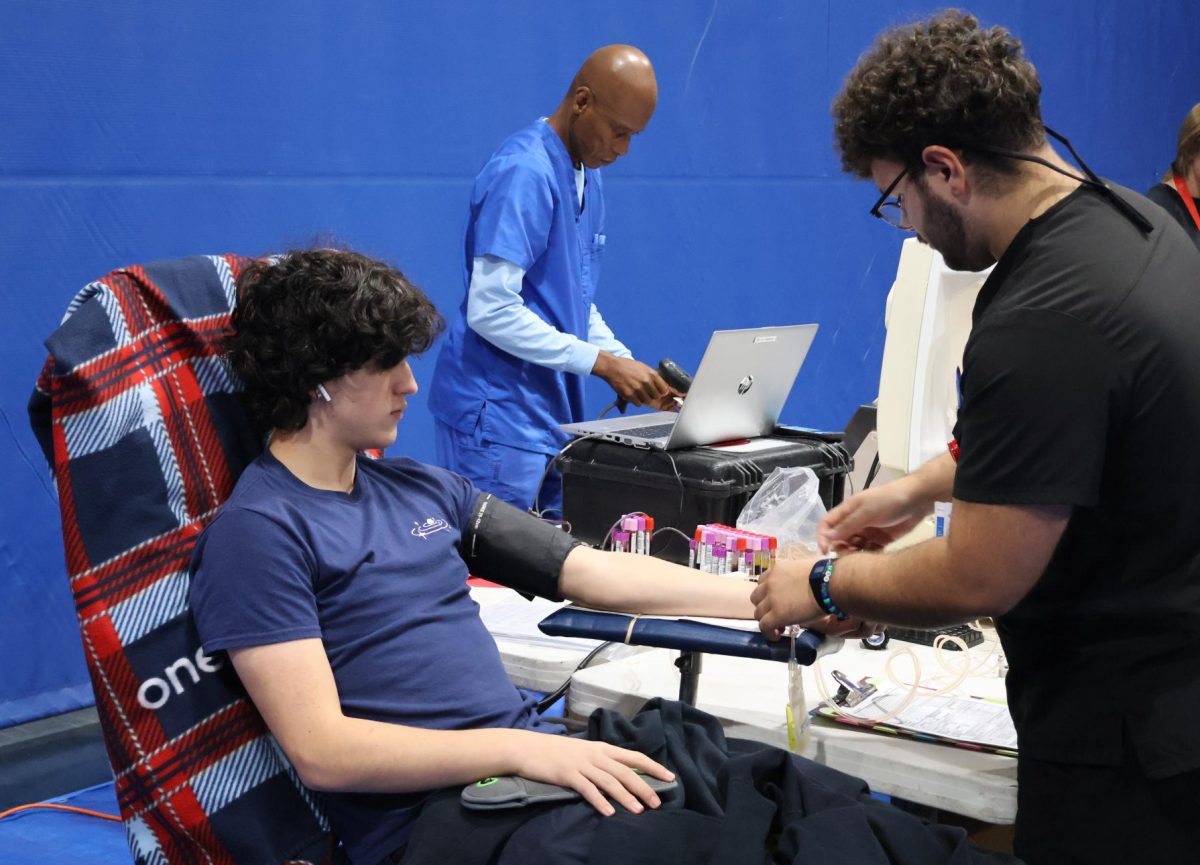 Junior Joaquin Sandaal donates blood during the annual One Blood drive, hosted in the Blue Dungeon by the HEAL Club. The drive, open to students and staff 16 and older, aimed to combat Miami’s blood shortage by collecting donations for local hospitals. Each pint donated has the potential to save three lives, showcasing the generosity and community spirit of participants.