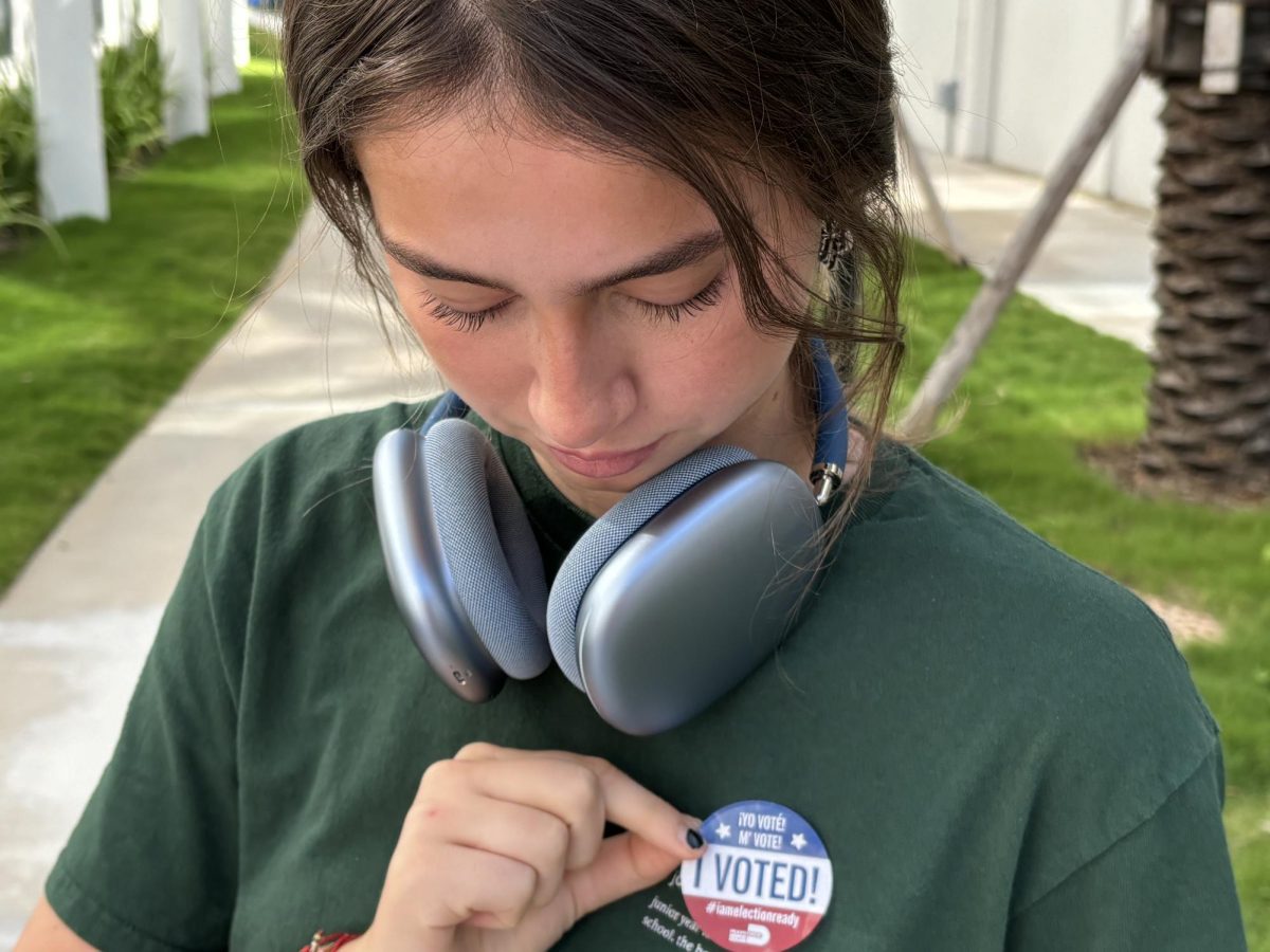 Senior Marianne Arana puts on her "I voted sticker".  Many seniors were able to vote during this year's election and voice their opinions. 