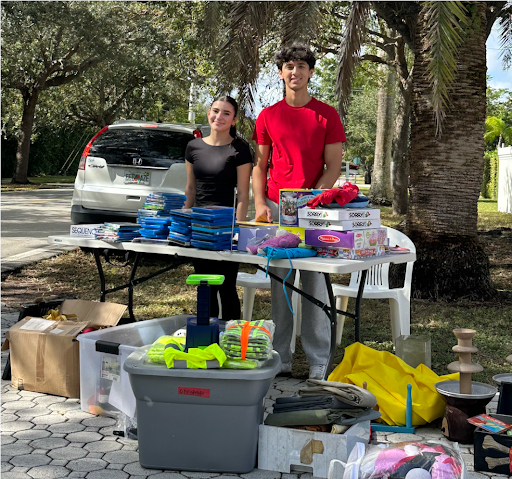 Nicolas Caraballo and Ruby Rodriguez-Valdivia at their garage sale which they used as an outlet to raise awareness, educate the public, and contribute to ongoing research efforts for Huntington’s Disease (HD). This was part of their involvement in the Health Occupations Students of America (HOSA).
