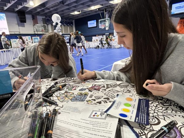 Students take a moment to add their own artistic elements on the coloring table set up by the Visual Arts dept. The Course Expo event showcased all academic and elective courses offered at the Upper School. The event took place on Dec. 4-5 in the Blue Dungeon.