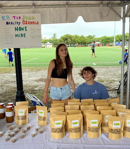 Senior Malena Pisoni prepares and sells her granola alongside her brother at the farmers' market in Key Biscayne last Saturday. While Pisoni is heavily time-committed to the college application process, she still manages to continue growing her profitable granola business.