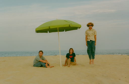 Dawson Daughtery, Cole Clisby, and Luke Fraby pose on the beach for their media photoshoot. The band met and grew up together on the beach and incorporated it into the songs and photos.