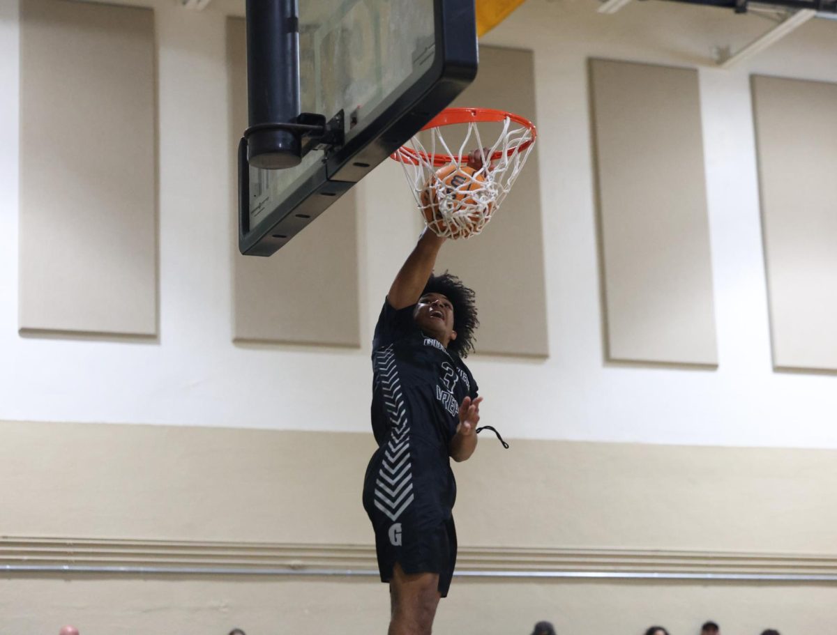 Junior Forward Samuel "Champ" Smith throws down a fast break dunk. Smith would end the game with double digits points and multiple dunks. 