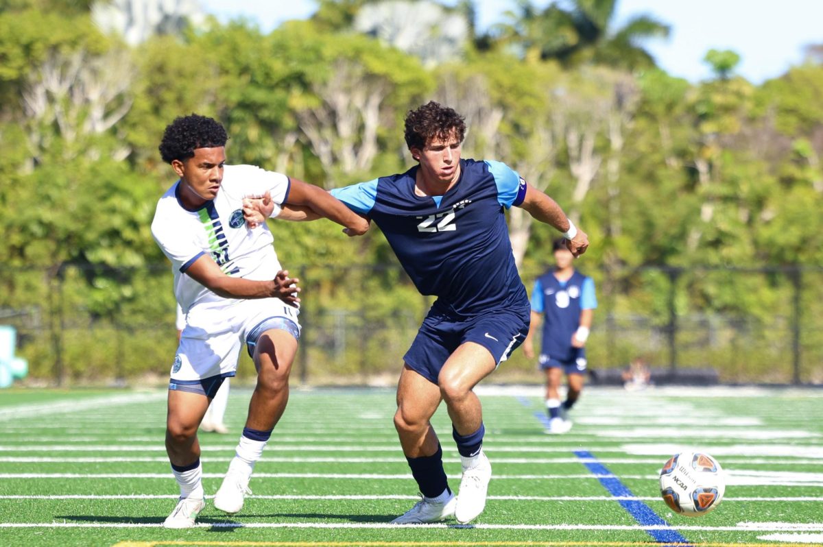 Junior defender Jacob Lombard pushes his defender out the way while going for the ball. Lombard who mainly plays defense has nine points on the season according to Maxpreps.