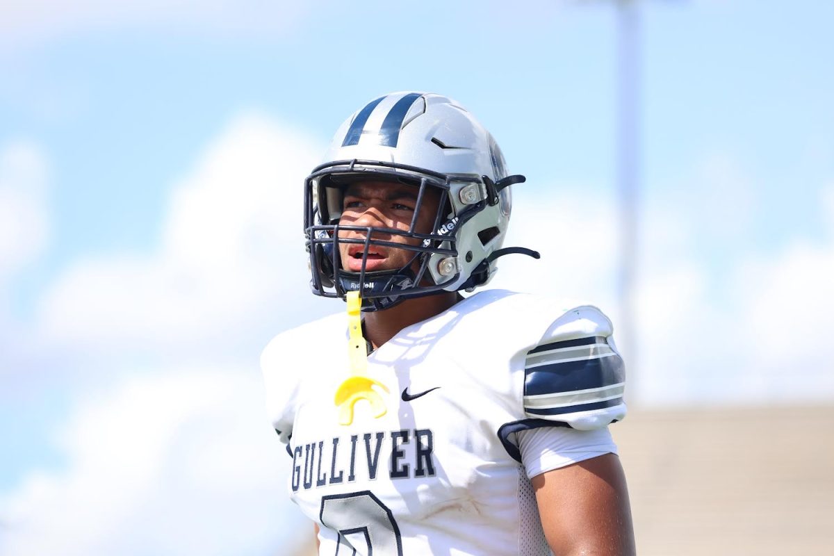 Junior Luc Carroll gets the play call from his offensive coordinator. Carroll would score multiple touchdowns during the game and serve as a big part in getting the team’s first win of the season. 