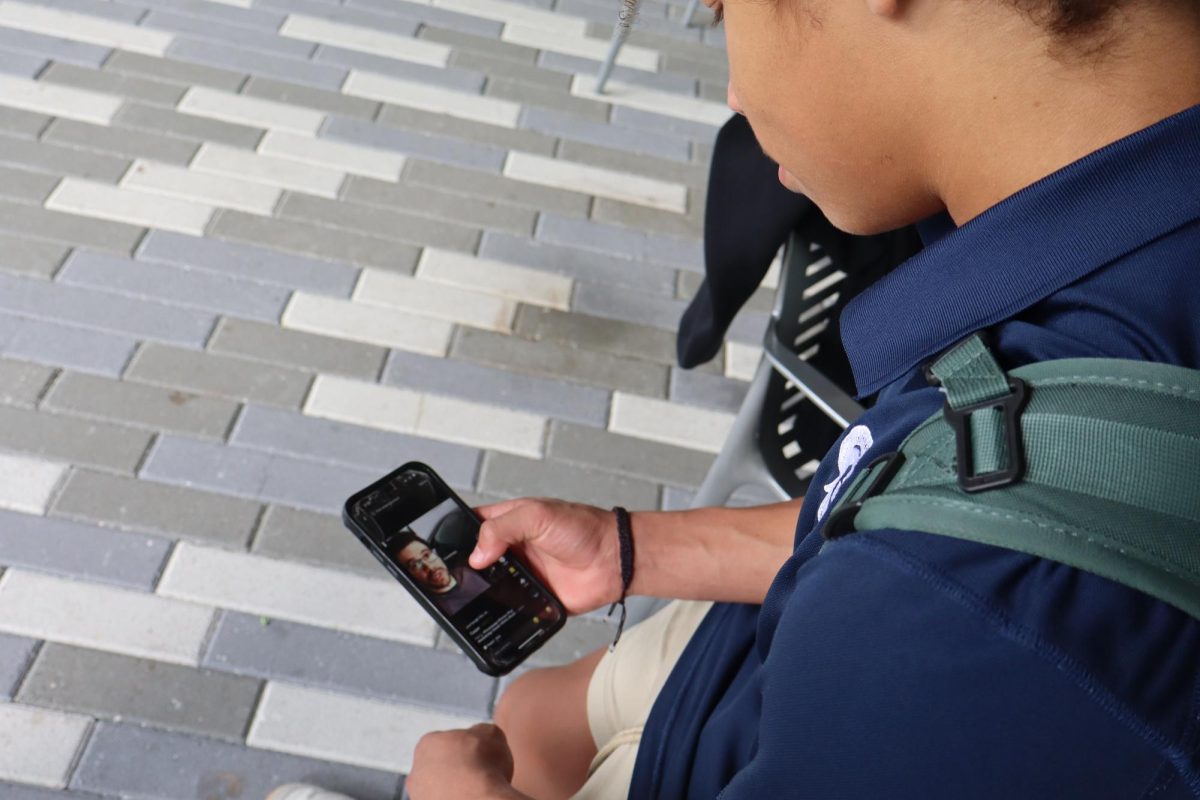 Senior Walker Allen scrolls through TikTok on his phone, immersed in the social media app's endless stream of content. As social media fuels connection, it also amplifies anxiety, with constant comparisons to curated highlights shaping teens’ perceptions of reality.