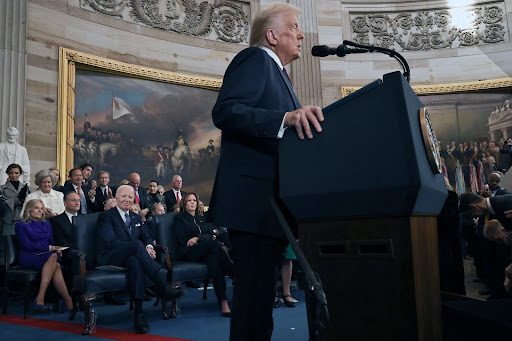 U.S. President Donald Trump speaks as former U.S. President Joe Biden and former U.S. Vice President Kamala Harris look on during inauguration ceremonies in the Rotunda of the U.S. Capitol on Jan. 20, 2025, in Washington, D.C. Donald Trump takes office for his second term as the 47th president of the United States. (Chip Somodevilla/Pool/AFP/Getty Images/TNS)