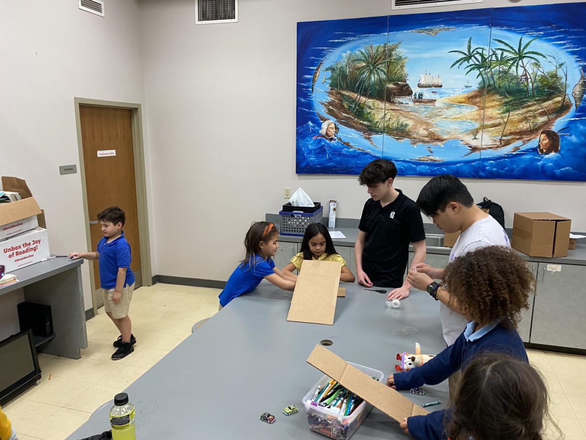 Sophomores Nico Vives and Ian Virelli help young students learn STEM topics through a hands on activity. This is the groups first year doing and hope to continue this for years to come. 