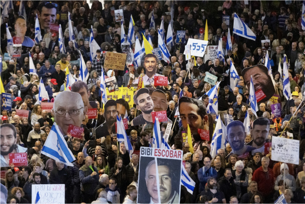 Protesters hold photos of hostages held in the Gaza Strip during a demonstration calling for the release of remaining hostages held in the Gaza Strip by Hamas on March 8, 2025 in Tel Aviv, Israel. Israel drafted a plan to escalate pressure on Hamas if they will not release the remaining hostages. 