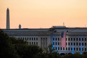 An American flag is unfurled from the roof of the Pentagon in Arlington, Virginia, U.S., September 11, 2021. REUTERS/Al Drago