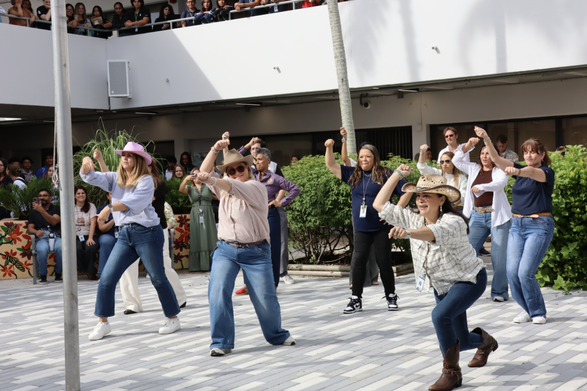 Faculty members perform a coordinated routine during the student-faculty dance-off in the Atrium on Friday morning. Their set included Beyoncé’s “This Ain’t Texas” and the 90s hit “Ice Ice Baby,” drawing cheers from the crowd. The event promoted sign-ups for the Race to Breakthrough.
