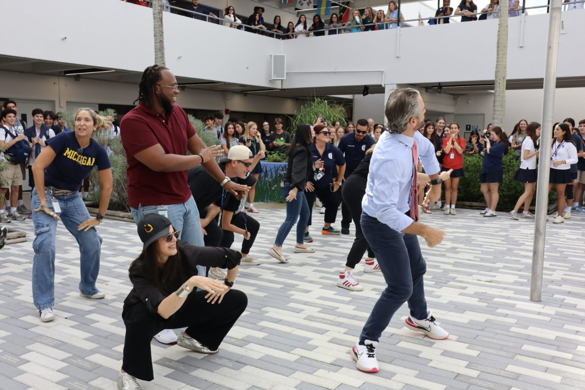Faculty members take the stage during the student-faculty dance-off in the Atrium on Friday morning. The lively performance, part of Breakthrough Spirit Week, was enjoyed by both students and faculty. The event promoted the Race to Breakthrough fundraiser, with registration closing today.