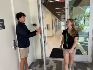 Sophomore Nicolas Sacerdote holds the door for junior Angelina Gouchee between classes. The small gesture reflects the values being discussed in the new programs. The program encourages students to practice values through daily actions on campus.