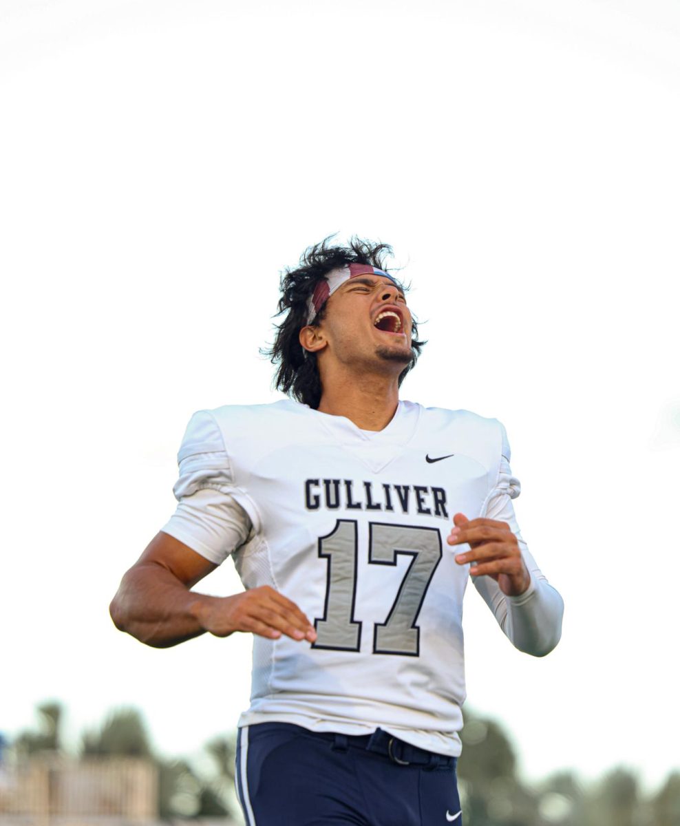Junior quarterback Brendan Berry yells during pregame. This photo was taken during the team's Raider chant which occurs right before the start of stretching. 