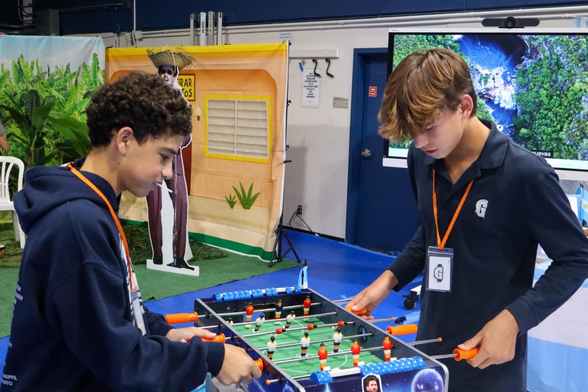 Students play a game of foosball in front of the Argentina display at the Hispanic Heritage Celebration event on Sept. 30. Colorful, interactive displays lined the Blue Dungeon, featuring interactive activities, food and information about many Hispanic countries. There were also displays completed by students in the Visual Arts department with information on various Hispanic artists. 