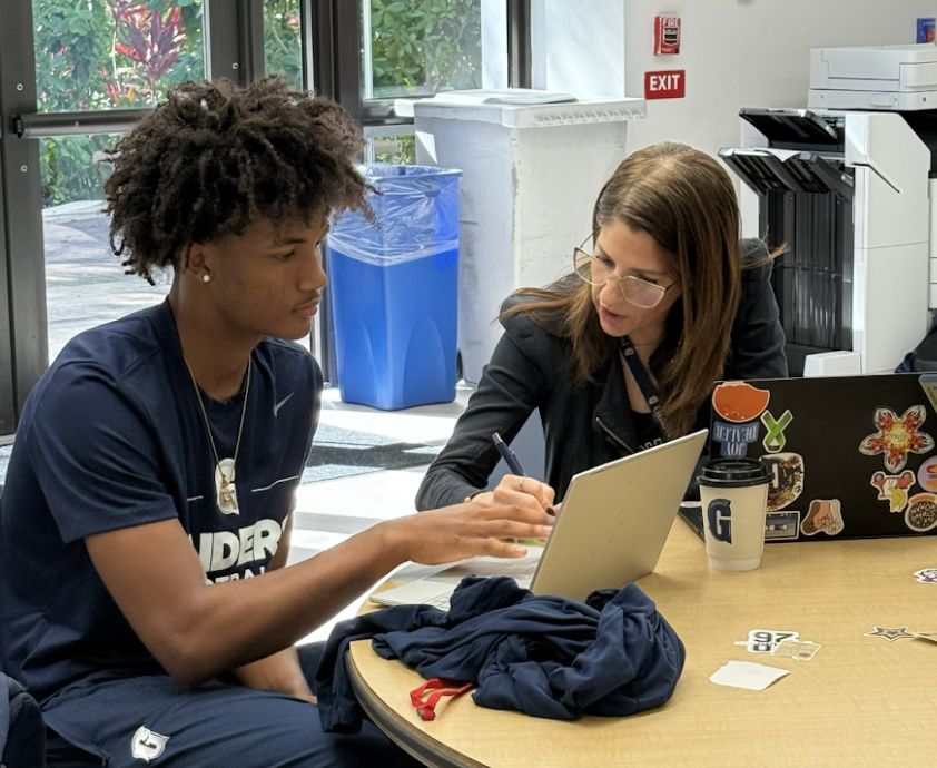 Senior Samuel Smith and college counselor Gina Pelaez work on applying to colleges at the student union. Students are expected to have their applications done and reviewed two weeks before the official deadline. Seniors were able to submit their applications to colleges with Nov. 1 Early Action deadlines at “Mission Submission.” 
