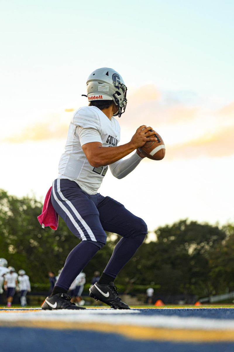 Quarterback, junior Brendan Beery, prepares to make a pass at the varsity football game against the Belen Jesuit Wolverines on Oct. 16. The Raiders clinched the win with a final score of 26-14.