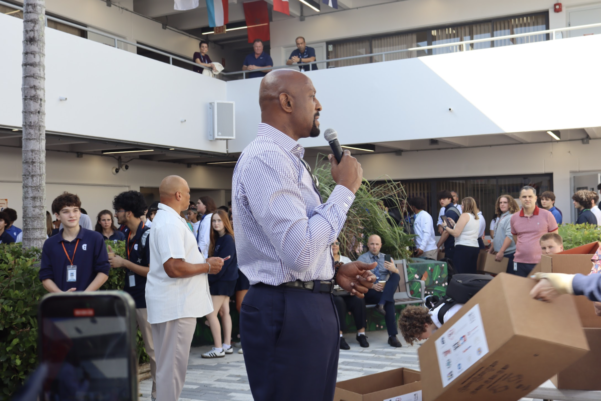 Alonzo Mourning kicks off the Dish Out Kindness Thanksgiving Drive with a speech expressing his gratitude. The former Miami Heat player brought this annual event to the school last year through the Overtown Youth Center, helping provide meals for 400 families.