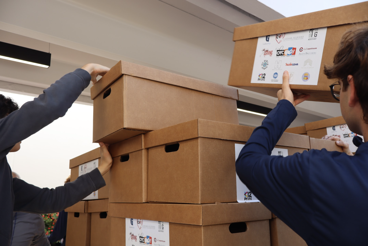 Students stack completed donation boxes as the final step of the Thanksgiving Drive. Their work helps support the Dish Out Kindness club’s long-term goal of fighting food insecurity through its annual events and community partnerships.