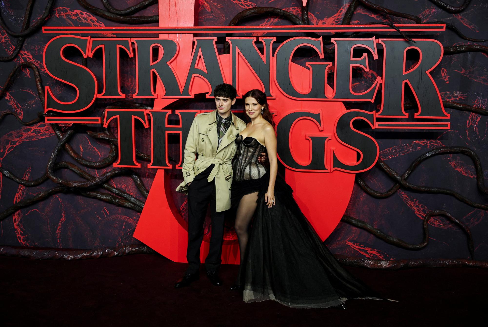 Cast members Noah Schnapp and Millie Bobby Brown attend the screening for the final season of the television series "Stranger Things", at Odeon Luxe Leicester Square in London, Britain, November 13, 2025. REUTERS/Isabel Infantes