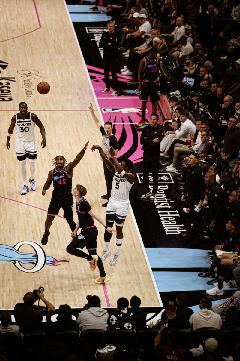 Star Guard Anthony Edwards rises up over his defender for a three pointer. Edwards's three point progression has opened up his game and has lead him to become a superstar in the league.