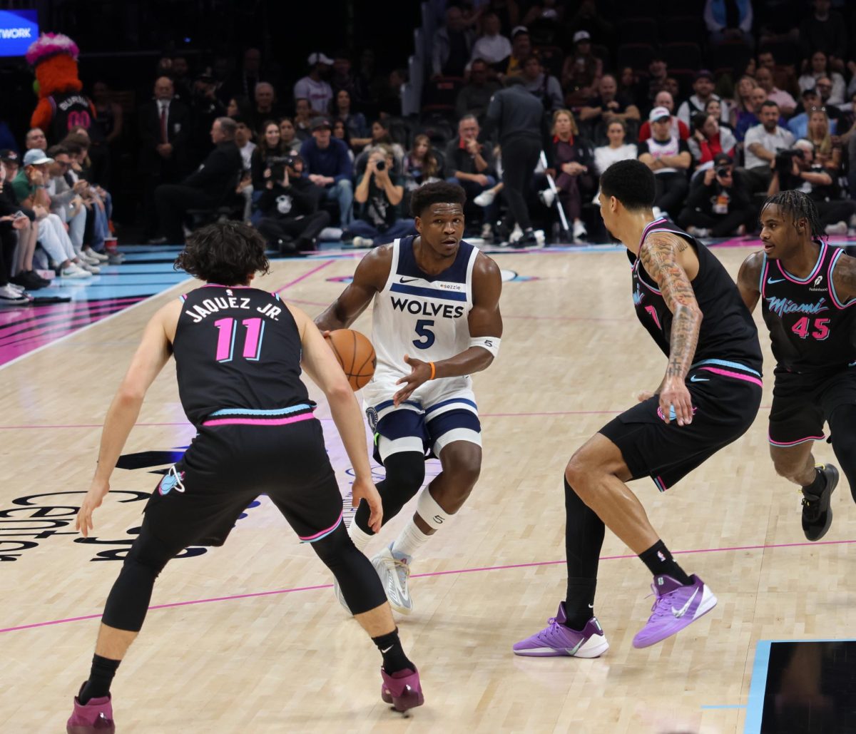 Shooting Guard Anthony Edwards dribbles through traffic trying to make an open lane. Edwards had been double teamed most of the game and tried to make do with the space he had.