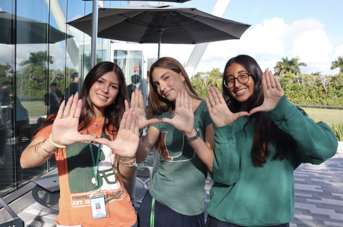 Juniors Emma Zambolo, Hanna Matuk, and Nora Henein show their Hurricane pride by wearing University of Miami gear on campus on game day. The orange and green represent the excitement surrounding Miami’s return to the Fiesta Bowl and national spotlight. School-wide spirit and student support highlight how the Hurricanes’ postseason run has energized the campus.


