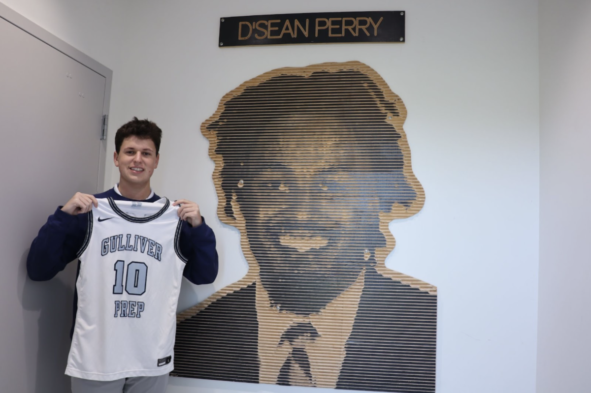 Senior team manager Evan Gitlin holds up the jersey he will wear on senior night, un-retiring D’Sean Perry’s number. Gitlin has been a part of the program since his sophomore year.
