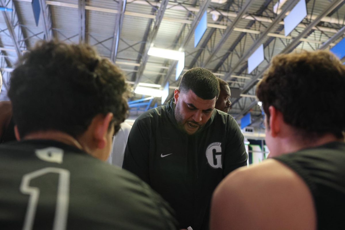 Head Coach Hossam Marquez goes over the gameplan minutes before tipoff. In his second year coaching, Marquez has made district semifinals twice. He has spent 17 years in the basketball program and is very focused on the future.  
