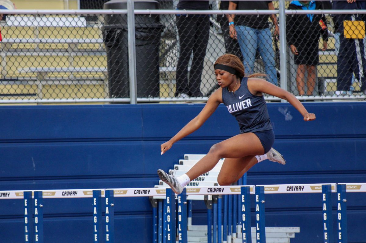 Sophomore Paris Aalani hurdles over the barrier. This is Aalani's 2nd year on the team, with her now being given a bigger role.