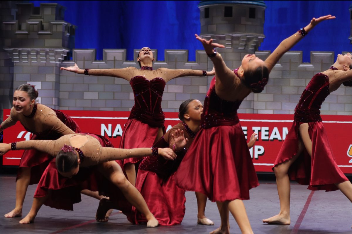 Charlotte Levengier, Lilly Haley and Mila Jude López take the stage during their jazz routine, “Squander,” at the UDA National Dance Team Championship.