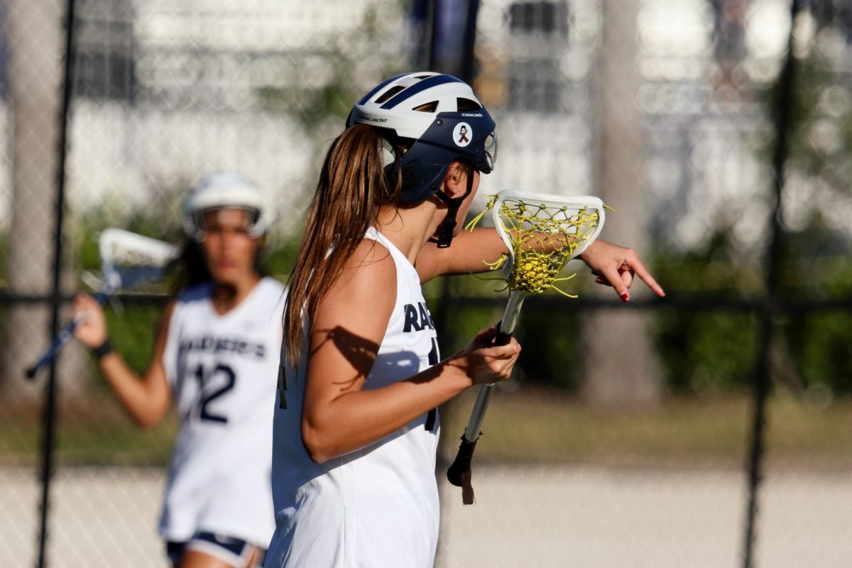 Senior Emma Die-Dienes directs her teammates as they move off ball. Dienes has been playing on the team for four years, and has played a major role each year.